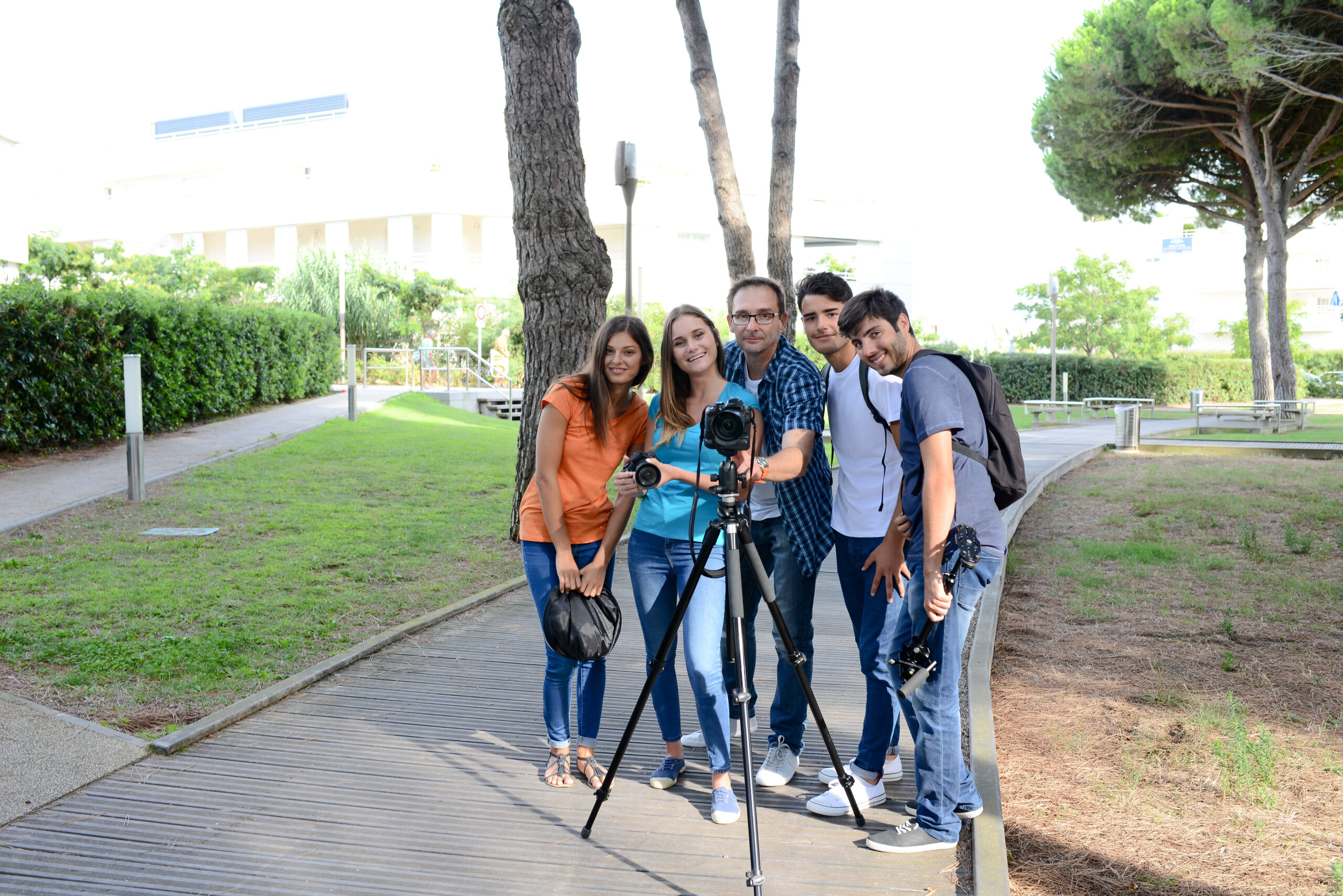 group of young photography students with teacher during an outdoor photo course