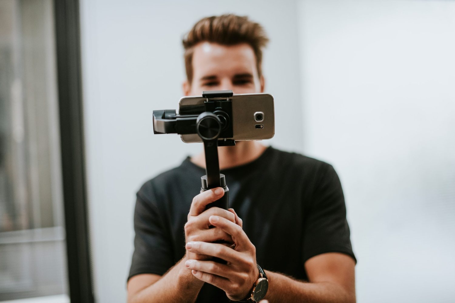 Man holding a gimbal with a phone